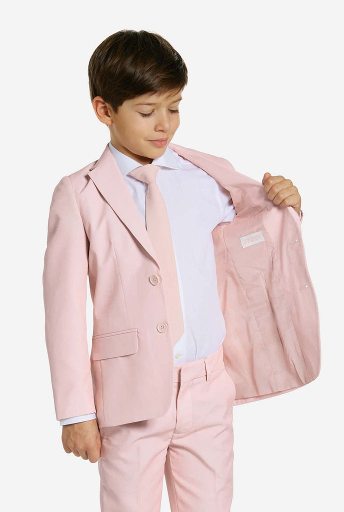 Kid wearing soft pink boys suit.